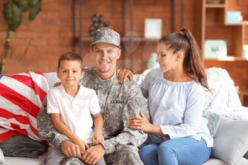 Happy military man with his family at home�