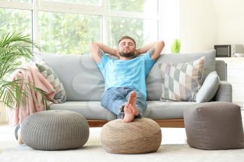 Handsome young man relaxing at home�