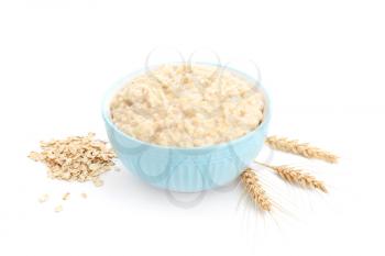 Bowl with tasty oatmeal on white background�