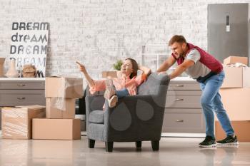 Young couple having fun after moving into new house�