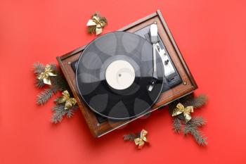 Record player and Christmas decor on color background�