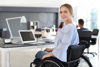 Handicapped young woman working in office�
