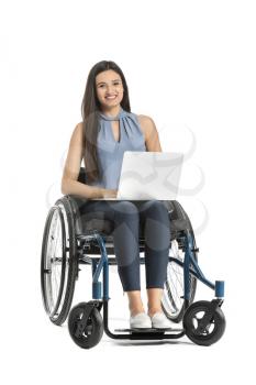 Beautiful businesswoman with laptop in wheelchair on white background�