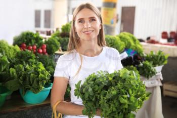 Woman with fresh mint at market�