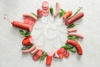 Frame made of different sausages on light background�