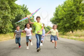 Little children flying kite outdoors�