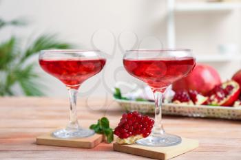 Glasses of fresh pomegranate juice on table�