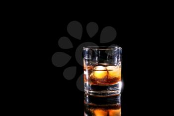 Glass of whiskey on dark background�