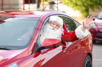 Santa Claus leaning out of car window�