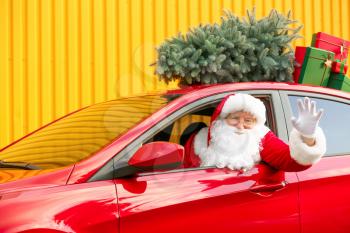 Santa Claus with gifts driving modern car�