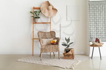 Interior of light room with wicker armchair�