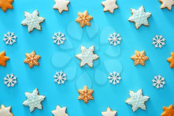 Tasty Christmas cookies and snowflakes on color background�