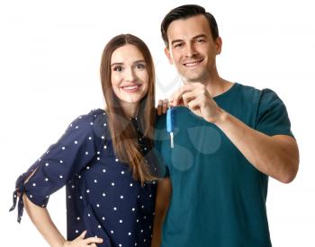 Happy couple with key from their new car on white background�