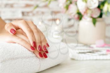 Woman with beautiful manicure in salon�