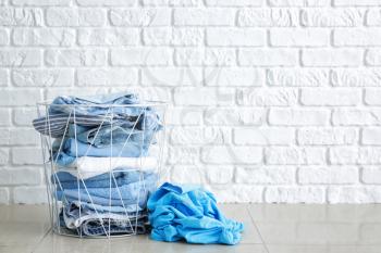 Basket with dirty laundry on floor�