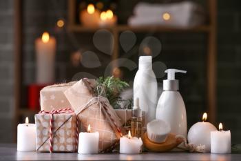Christmas gift boxes with products for spa treatment on table�
