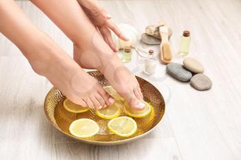 Young woman undergoing spa pedicure treatment in beauty salon�