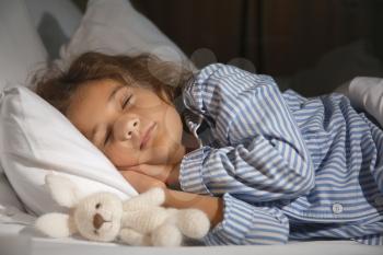 Cute little girl sleeping in bed at night�