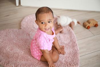 Portrait of cute African-American baby at home�
