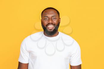 Handsome African-American man on color background�