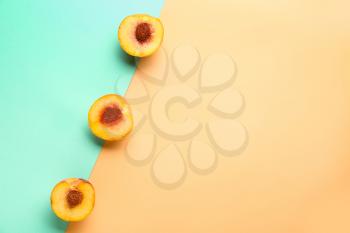 Sweet ripe peaches on color background�