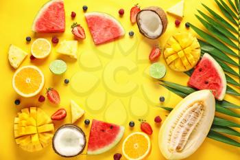Frame made of ripe fruits and berries on color background�