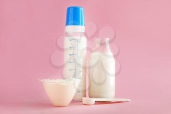 Bottles of milk with baby formula on color background�