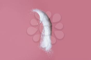 Throwing of sand sugar against color background�