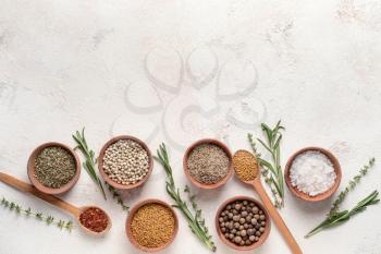 Different dry herbs and spices on white background�