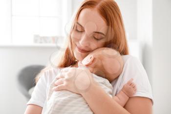 Mother with cute baby at home�