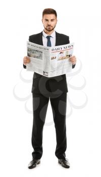 Handsome businessman with newspaper on white background�