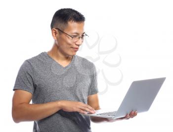 Male Asian programmer with laptop on white background�