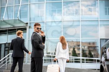 Young celebrity with bodyguards in airport�