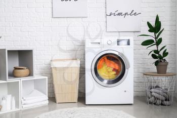 Interior of home laundry room with modern washing machine�