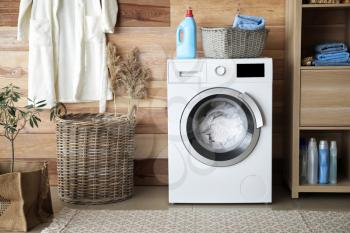 Interior of home laundry room with modern washing machine�