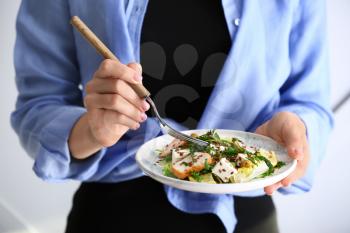 Woman with plate of tasty salad, closeup�