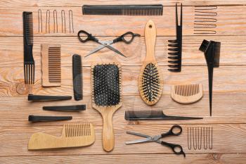 Set of hairdresser tools on wooden background�