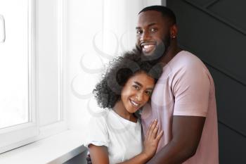 Portrait of happy African-American couple near window�