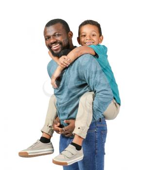 Portrait of African-American man with his little son on light background�