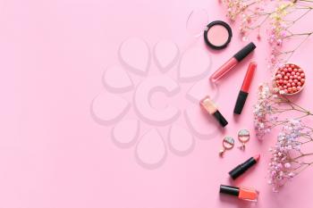 Set of decorative cosmetics, flowers and accessories on color background�