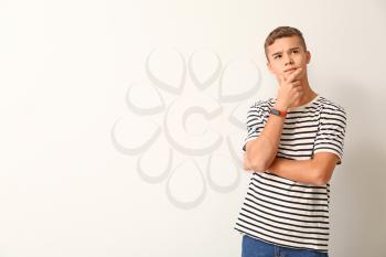 Thoughtful teenage boy on white background�