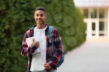 Portrait of teenage African-American student outdoors�