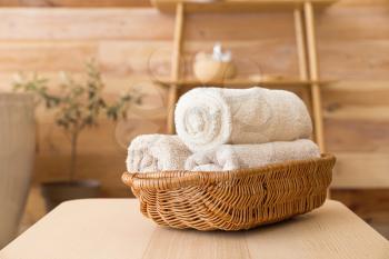 Basket with clean towels on table in bathroom�