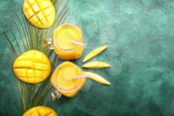 Composition with tasty mango and juice on color background�