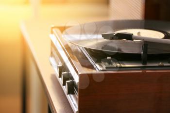 Record player with vinyl disc in room, closeup�