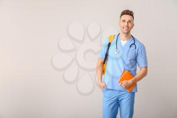 Male medical student on light background�