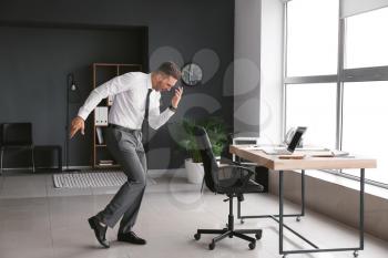 Young businessman dancing in office�
