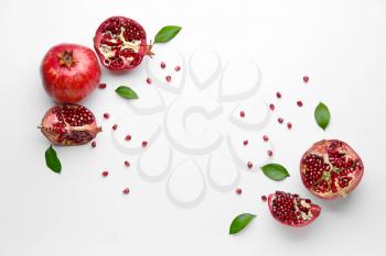 Ripe tasty pomegranates on white background�