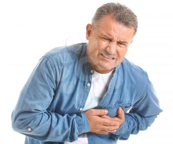 Mature man suffering from heart attack on white background�