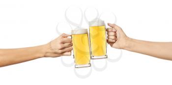 Hands clinking mugs of beer on white background�